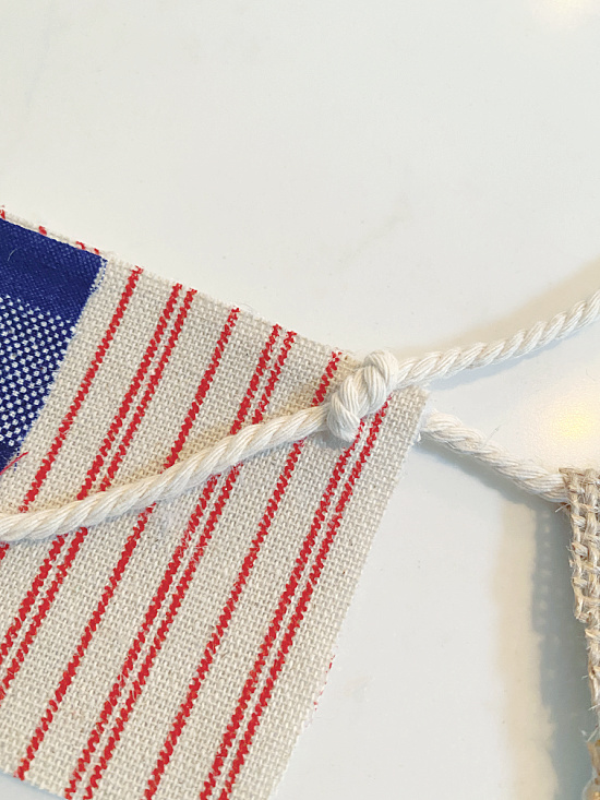 cotton twine through hole in flag