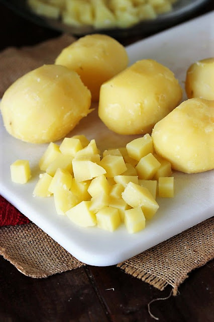 Cubed Peeled Potatoes on Cutting Board Image