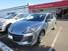 Scraped bumper on 2013 Mazda 3 before collision repairs at Almost Everything Auto Body.