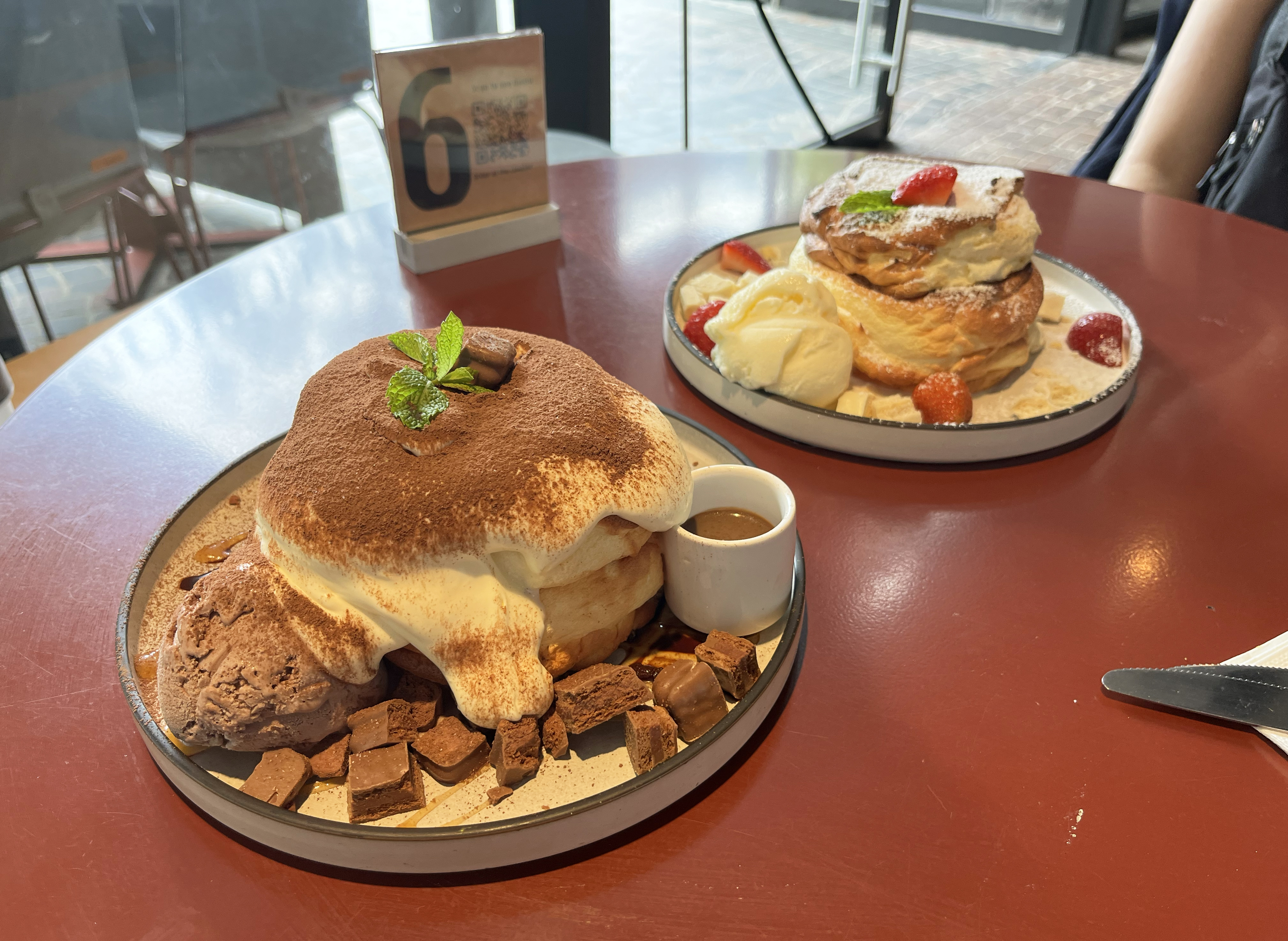 In the foreground is the Tiramisu pancake, in the background is the Thai Tea Pancake