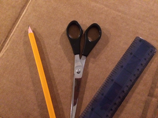 Piece of card, pencil, scissors and a ruler