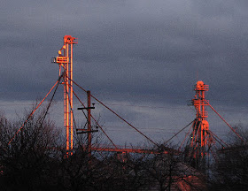 light reflected on grain elevator towers