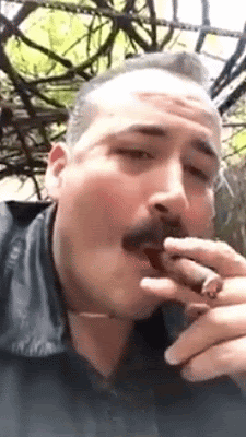 C 1/2 Blurry animation of handsome man wearing black leather jacket and smoking a cigar