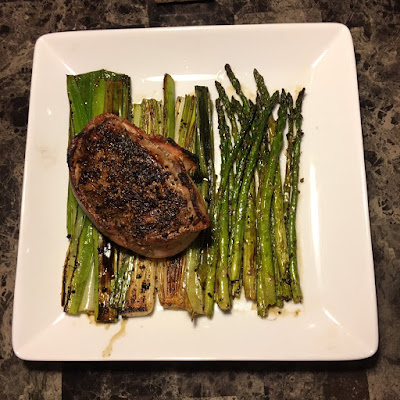 Bacon wrapped sirloin filet with grilled leeks and asparagus