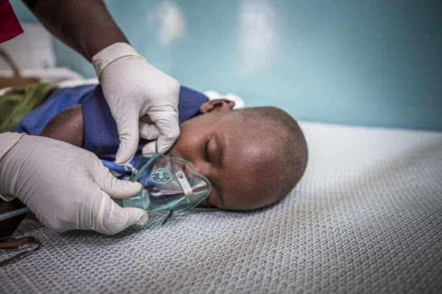 Save the Children emergency health officer Jedidah Onyango fits an oxygen mask to three year-old pneumonia patient Jackson at Turkana County referral hospital, Kenya