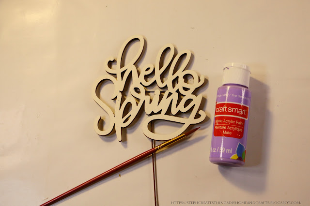 Hello Spring sign, paint, and paintbrush