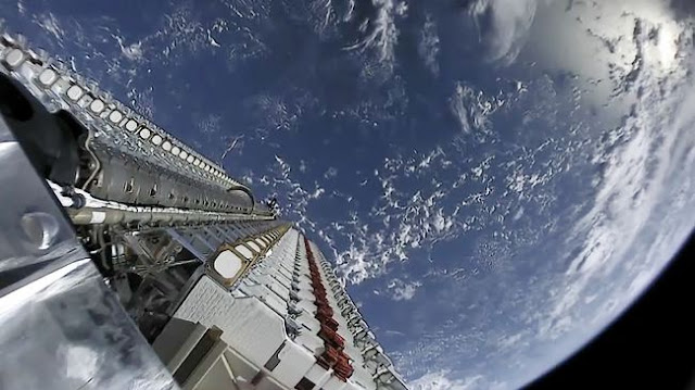 A view of SpaceX's first 60 Starlink satellites in orbit, still in stacked configuration, with the Earth as a brilliant blue backdrop on May 23, 2019.