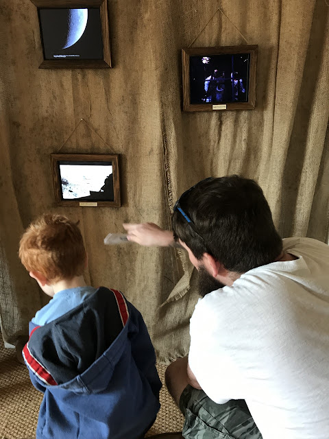 Father and son watching apollo launches on 4 small screens