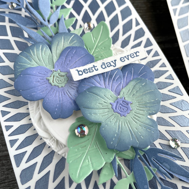 Pansy Burst cards created with: The Crafters Workshop circular rings slimline stencil, stencil butter denim and pearl white; Paper Rose etched pansy die; Tim Holtz distress oxide faded jeans, speckled egg, shaded lilac, engraved 3D embossing folder; Scrapbook.com delicate leaves; Pinkfresh clear drops iridescent gems
