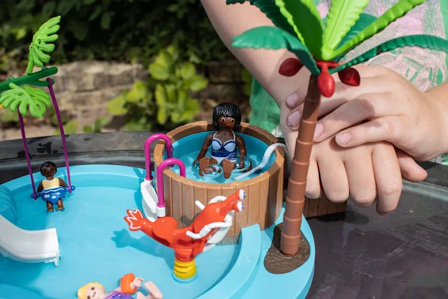 Close up of the children's Playmobil and making bubbles in the jacuzzi