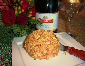 this is a cheese ball rolled in nuts and has a bottle of Champagne in the back
