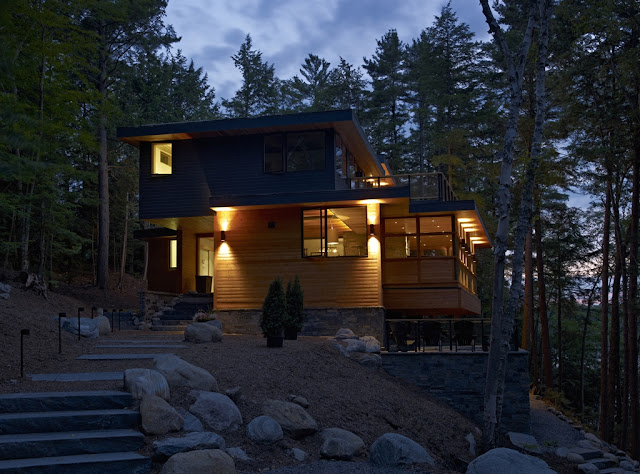 Photo of the forest house at sunset as seen from the walkway to the house