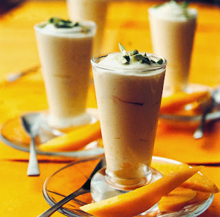 Creamy Saffron Yoghurt Recipe: An indulgent vegetarian dessert for Diwali, served in glasses topped with pistachio nuts and accompanied by mango