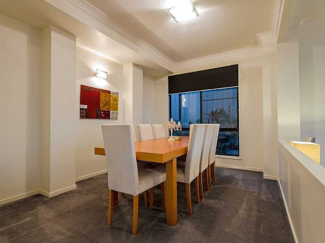 Picture of modern dining room with wooden table and white chairs