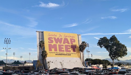 Early morning sun reflects off the large Santa Fe Springs Swap Meet sign