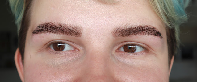A photo of eyebrows with regenerating cream on