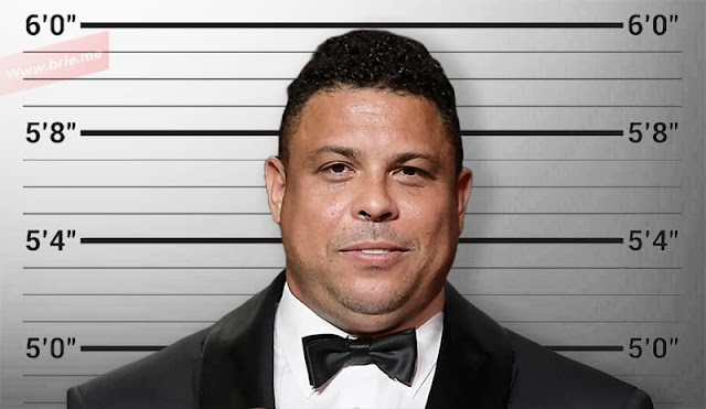 Ronaldo Nazario posing in front of a height chart background