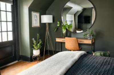 Modern bedroom with green wall and mirror