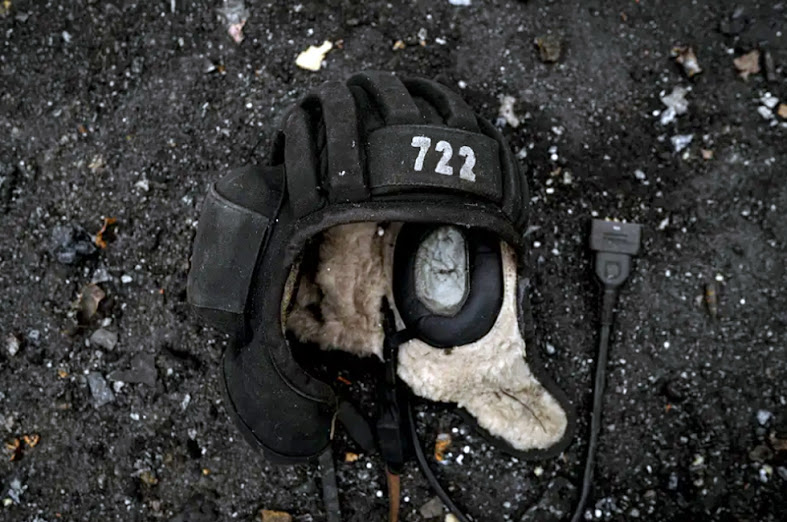 On Wednesday, March 9, 2022, a tank operator's hat rests on the ground next to a destroyed Russian tank in Irpin, Ukraine, on the outskirts of Kyiv.