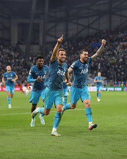Tottenham Hotspur players celebrate qualifying for the Uefa Champions League last 16 after beating Marseille 2-1