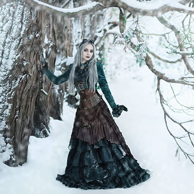 Woman wearing gothic steampunk clothing (aka steamgoth) in emerald green, brown and black. Gothic Victorian Steampunk goths.