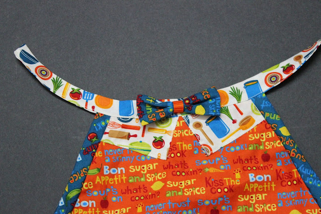 handsewing the bow-tie to the apron