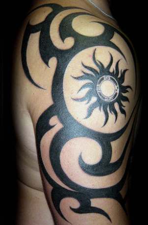Upper arm tattoos in the form of a wraparound bands are very popular