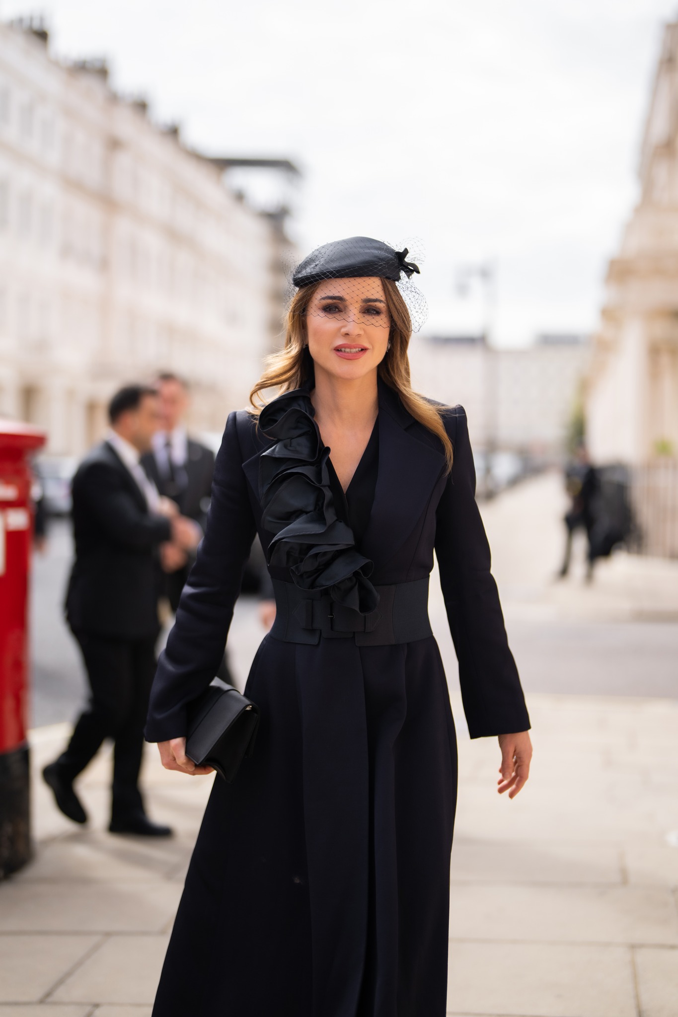 Queen Rania wore an old black coat from November 2001 Windsor visit to Queen Elizabeth II's funeral
