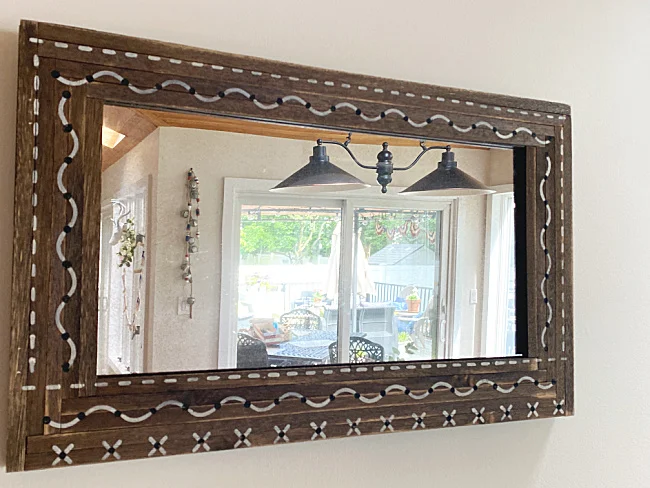 boho mirror hanging in the kitchen