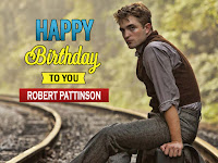robert pattinson images, he is sitting on railway track [rail lines] in grey color dress and brown waistcoat