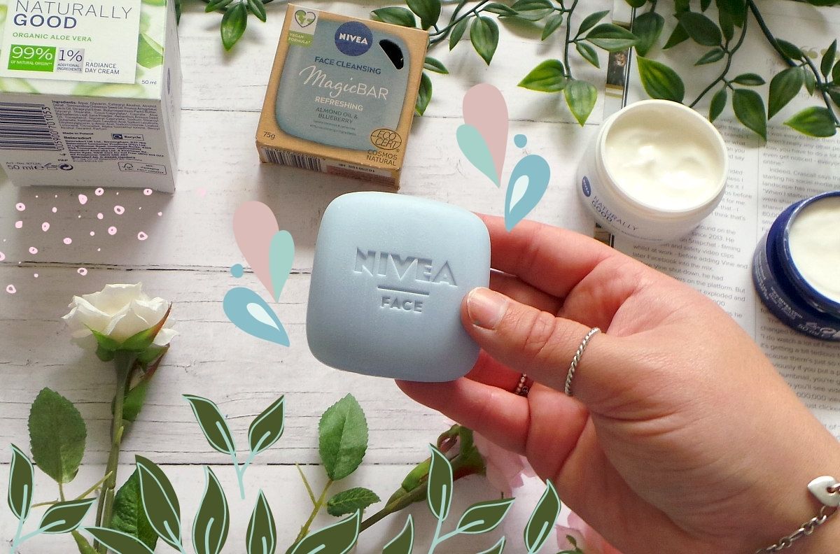 A hand holding a grey bar of soap with doodles of leaves and flowers around it