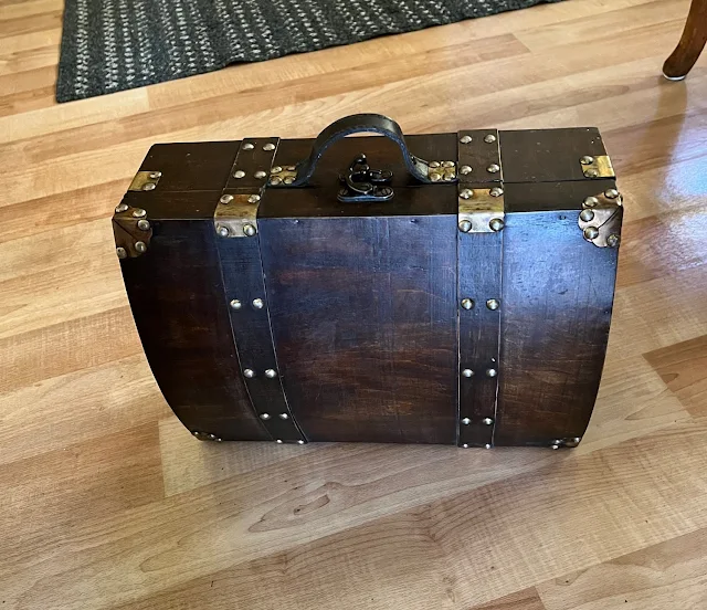 Photo of a wooden decor suitcase from Goodwill.