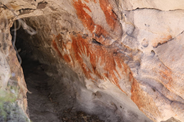 Red stencil handprints at Marlong Arch Sandstone rock formation