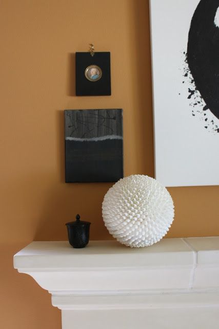 Pumpkin orange wall with black seascape painting by Michele of Hello Lovely