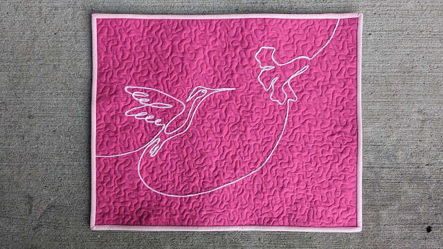 Pink hummingbird mini quilt using yarn couching