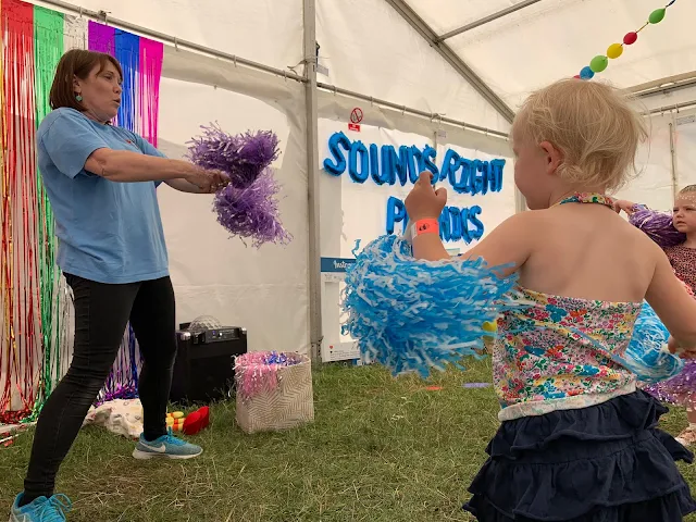 Shaking pompoms at the 3 foot people festival in Chelmsford Sounds Right Phonics class