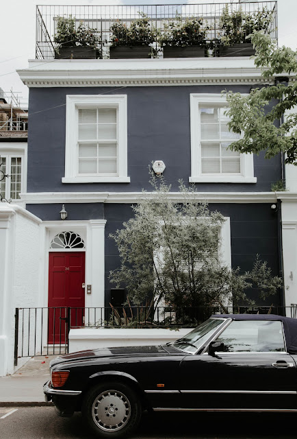 townhouse with black car parked outside:Photo by Nik Guiney on Unsplash