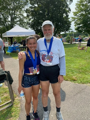 Alana and Larry show off their age-group medals in the Run/Walk to Remember race Aug. 1 in downtown North Attleboro.