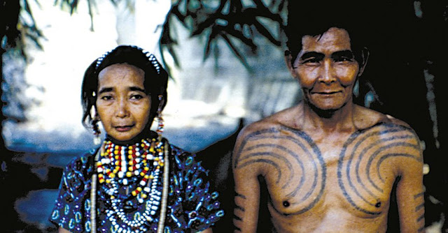 Gaddang woman with bead necklaces and man with tattoo