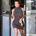 Kim Kardashian shows off her curvy body in a tight dress which displayed her bodyshaper