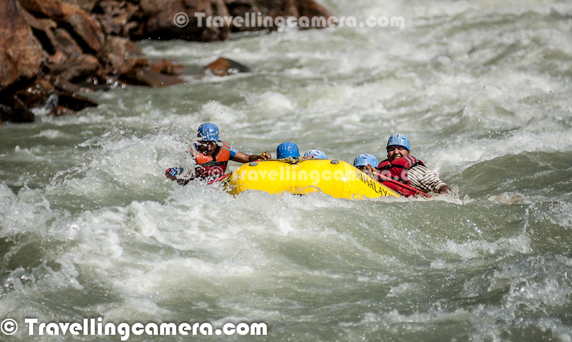 Rafting or white water rafting is one of the challenging recreational outdoor activity using an inflatable raft to navigate a river or other bodies of water having different levels of water-current. This is usually done on white water or different degrees of rough water, in order to thrill and excite the raft passengers. Rafting is considered an extreme sport, as it can be dangerous as times. This Photo Journey shares some of the photographs of Rafting in Risikesh, which is one of the popular places in India to do White Water Rafting.Recently we were in Rishikesh with office friends and Rafting was one of the top item in our list of things we wanted to do. We started in bus from Aspen Camps in Rishikesh and then boarded to jeeps with rafts. We had to start from Marine Drive which is a huge Ganges beach with enough space for folks to prepare and get started. Marine Drive is a place, strategically identified to start Rafting. Shivpuri is another preferred place to start Rafting. Idea is to make people comfortable with various types of water-rapids and then gradually start enjoying various stretches in river. Ganges provides a good range of water rapids and makes rafting an unmatchable experience.Rishieksh is one of the main places to do rafting in North India. Long time back I had done rafting in Vyas River near Kullu and that time all other rafters were professionals and I was covering a particular camp for Tourism Development program. Since I was not much involved in rafting activities, I couldn't enjoy it much that time. At Rishikesh, we had a wonderful coach/leader, who made rafting experience as great fun.After reaching Marine Drive Ganges beach, everyone of us got life jackets, a pedal and helmet. All three important things were with us and coach told us the best ways of using these three. All set with tight life-jacket, well settled helmet and appropriately gripped pedals we stepped into the raft after cleaning our feet in ganges water. It's recommended not to bring sand particles inside the raft, which can harm later. The coach threw chilling ganges water on us to start the journey in chilled water of ganges with different current levels. Coach with one of other Rafting professional entered into the raft. Then he briefed everyone of us about different commands like fast forward, move backward, stop etc. Initially it was difficult for us to gram every details of each command, but every command was very important for best rafting experience.Apart from basic Rafting commands, coach/leader also tells about basic rules of White Water Rafting. He also understands about each person sitting in the raft about their past experience with water. He also shares some basic steps for people who are not comfortable while sitting in raft. Of course, there are some standard rules to sit on a raft and make yourself comfortable even when body needs to stick with raft through feet in a particpular position. The Thumb rule is to listen your coach and follow him without any alternation, even in difficult situation. Idea is to trust the coach/Leader and follow his/her commands with any panic.So we started with baby steps and raft started moving towards Rishikesh (Lakshman Jhoola). For first 10 minutes, we were really slow and it was more of practice session, wehere coach was making us prepared for following his commands throughout the whole stretch we had to do in river. After practicing all the commands and moving our raft in circle, coach/leader asked us to stand on boundaries of raft and balance with pedal mounted on raft top. None of us could gather courage to stand on the boundaries and negotiated with coach/leader to stand inside the raft and try to balance with pedals. It was one of the major test for us and raft moves a lot. Many times, some of us stumbled and others were getting impacted because of imbalance. This task completed and coach/leader asked us to move forward.First we encountered Good Morning Rapid which is the beginning of Rafting experience. Good Morning rapid always come of the way and it doesn't matter that what was your starting point :). It was very basic but yet exciting because of first encounter with relatively fast flow of water-waves. Before hitting the rapid, some of the screaming while others were laughing to hide the fear :)All these photograph in this Photo Journey are clicked day before we did rafting. One day before we did rafting, we kept going to different places around river bed to shoot rafts sailing through high rapids of Ganges white water. Above photograph shows one of the raft getting up side down at Golf Course. One of the other leader jumped into the water to rescue raft and then every rafter. Within 5-8 minutes everyone was back on top of raft and moved forward towards Laxman Jhoola, which was end point. In such situations, ideally, everyone should listen carefully to what leader says and follow with panic. Things can get worse in case of avoidance of leader commands.The modern rafts are inflatable boats, consisting of very durable, multi-layered rubberized (hypalon) or vinyl fabrics (PVC) with several independent air chambers. The length varies between 3.5 meters and 6 meters, the width between 1.8 meters and 2.5 meters. The exception to this size rule is usually the packraft, which is designed as a portable single-person raft and may be as small as 1.5 metres long and weigh as little as 1.8 kilograms.Rafts come in a few different forms. In Europe and Australasia, the most common is the symmetrical raft steered with a paddle at the stern. Other types are the asymmetrical, rudder-controlled raft and the symmetrical raft with central helm (oars) or Stern Mounts with the oar frame located at the rear of the raft. Rafts are usually propelled with ordinary paddles and or oars and typically hold 4 to 12 persons. In Russia, rafts are often hand made and are often a catamaran style with two inflatable tubes attached to a frame. Pairs of paddlers navigate on these rafts. Catamaran style rafts have become popular in the western United States as well, but are typically rowed instead of paddled.Check out more at - http://en.wikipedia.org/wiki/RaftingAfter Good-Morning rapid, we crossed - Black Money, Three Blind Miles, Cross Fire, Shivpuri, Return to center, Roller Coaster, Tea off, Golf Course, Club House, Initiation, Body Surfing, maggie point & Cliff jumping, Double Trouble, Hilton and fianally Ram Jhoola. I went till Golf Course only and most of the other rafts from our group ended at Lakshman Jhoola.The most suitable time for River Rafting in Rishikesh is from September to November and from March to April-May. One of the best rivers in the world to experience the sheer exhilaration of white water rafting, it is the sheer invincible power of the Ganga river that often attracts the adventurer to the challenging sport of river rafting at Rishikesh.Generally White Water Rapids are divided into 6 levels of difficulty.Grade 1: Very small rough areas, might require slight maneuvering. (Skill Level required is very BasicGrade 2: Some rough water, maybe some rocks, might require some maneuvering. (Skill level: basic paddling skillGrade 3: Whitewater, small waves, maybe a small drop, but no considerable danger. May require significant maneuvering. (Skill level: experienced paddling skills)Grade 4: Whitewater, medium waves, maybe rocks, maybe a considerable drop, sharp maneuvers may be needed. (Skill level: whitewater experi\\Grade 5: Whitewater, large waves, large volume, possibility of large rocks and hazards, possibility of a large drop, requires precise maneuvering. (Skill level: advanced whitewater experience)Grade 6: Class 6 rapids are considered to be so dangerous that they are effectively unnavigable on a reliably safe basis. Rafters can expect to encounter substantial whitewater, huge waves, huge rocks and hazards, and/or substantial drops that will impart severe impacts beyond the structural capacities and impact ratings of almost all rafting equipment. Traversing a Class 6 rapid has a dramatically increased likelihood of ending in serious injury or death compared to lesser classes. (Skill level: successful completion of a Class 6 rapid without serious injury or death is widely considered to be a matter of great luck or extreme skill and is considered by some as a suicidal venture)In Rishikesh, we have crossed rapids of Level-3 difficulty as max. But it was great fun to face level three rapids. Water comes on to your body and pushes back and sometimes people get down into the water due to thrust.White water rafting can be a dangerous sport at times, especially if basic safety precautions are not observed. Both commercial and private trips have seen their share of injuries and fatalities, though private travel has typically been associated with greater risk. Depending on the area, safety regulations covering raft operators may exist in legislation. These range from certification of outfitters, rafts, and raft leaders, to more stringent regulations about equipment and procedures. It is generally advisable to discuss safety measures with a rafting operator before signing on for a trip. The equipment used and the qualifications of the company and raft guides are essential information to be considered.Like most outdoor sports, rafting in general has become safer over the years. Expertise in the sport has increased, and equipment has become more specialized and increased in quality. As a result the difficulty rating of most river runs has changed.