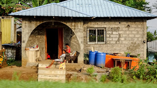 Locals sitting outside their houses in Bioko