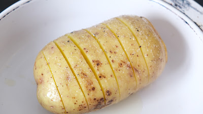 Hasselback potato in oil, salt and pepper