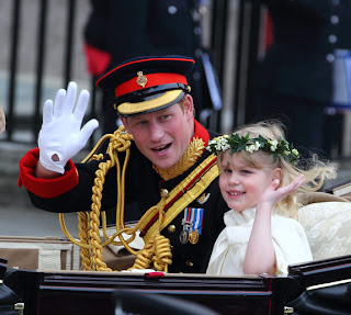Prince Harry and bridesmaid Lady Louise Windsor depart the Royal Wedding in a carriage.