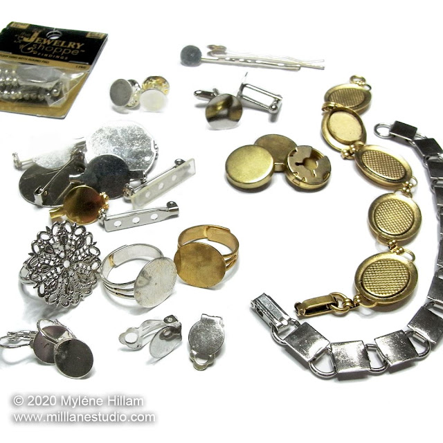 Selection of gold and silver flat pad jewellery findings, including, earrings, rings, brooches, button covers, bracelets and hair clips