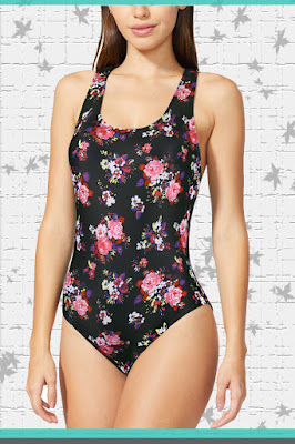 A woman wearing a black floral one-piece swimsuit
