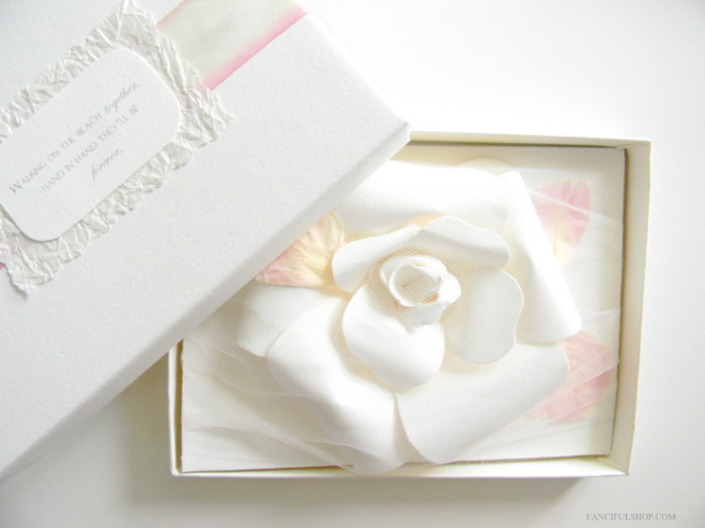 As you open the box each invitation is topped with a handmade gardenia