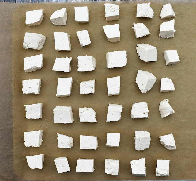 cubed tofu on a lined baking tray