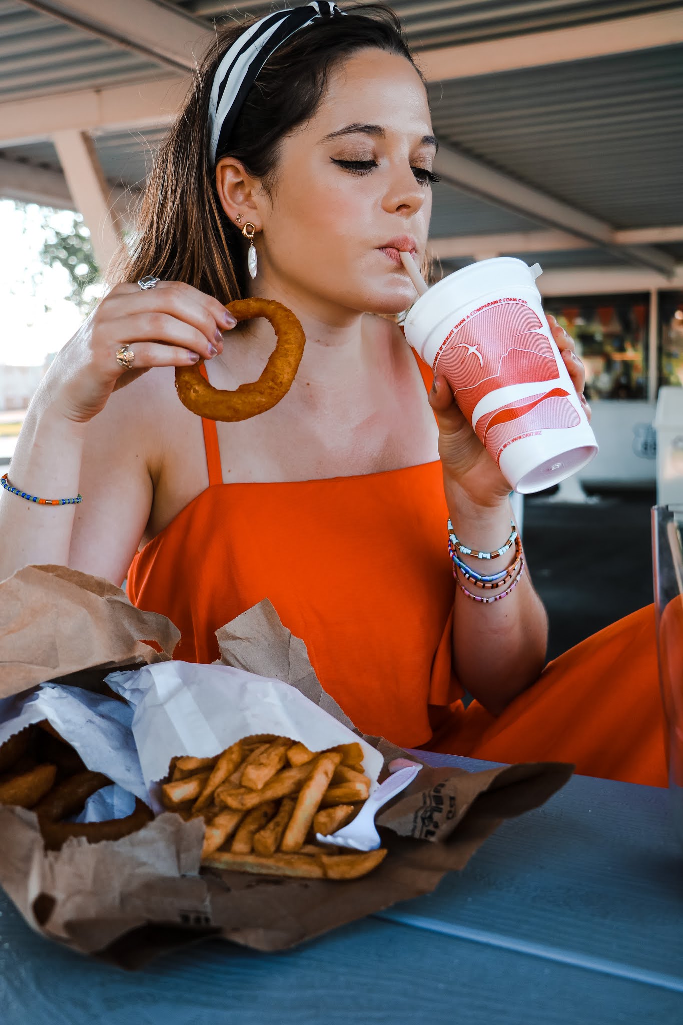 Nyc style influencer, Kathleen Harper eating fast food during a photo shoot.