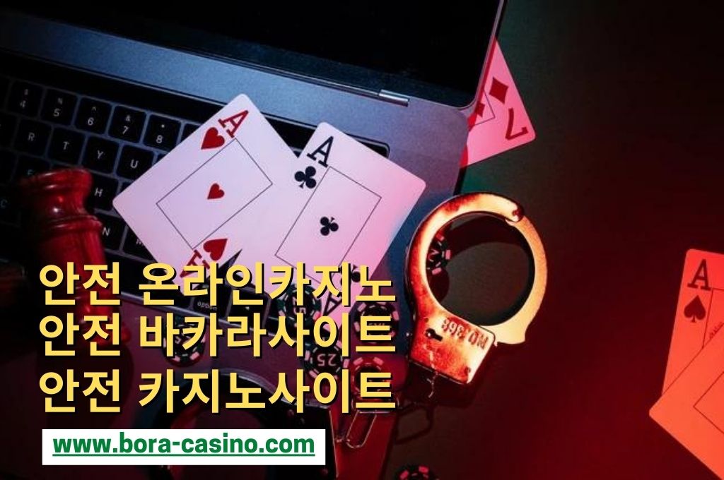 In a dark room place a laptop with hand cuffs, wooden gavel, casino chips and cards on the top